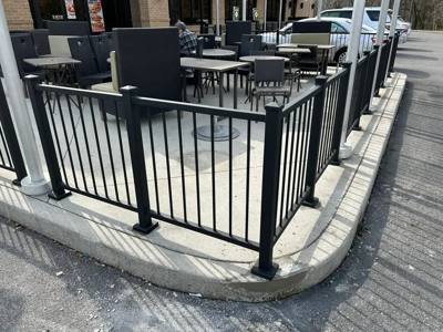 Black patio railings surrounding outdoor tables and chairs