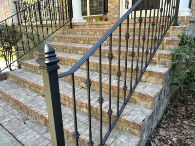 Black stair railing with shaped balusters and a pointed post cap