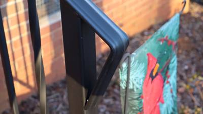 Close-up of a black handrail with a rounded return end