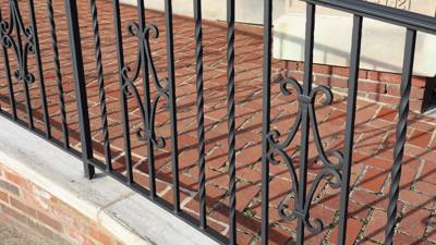 Close-up of twisted pickets and decorative scrolls in a porch railing