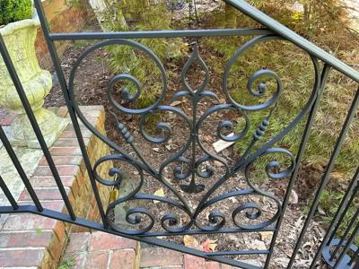 Close view of a railing panel with symmetrical scrolls and leaf shapes