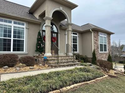 Columned arched entrance with stone steps and discreet side handrails