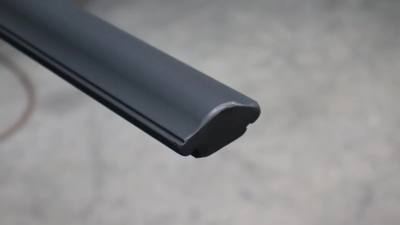 Cross-section detail of a contoured metal handrail profile