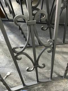 Curved scroll ornaments and a decorative collar on a workshop railing panel