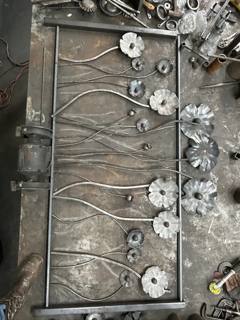 Decorative flower panel laid flat on a fabrication bench