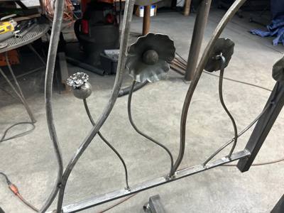 Flower-and-stem panel under fabrication on the workshop floor