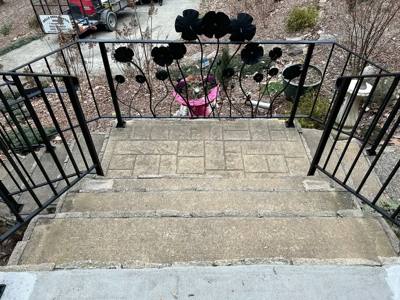 Flower-decorated railing panels overlooking outdoor stone steps