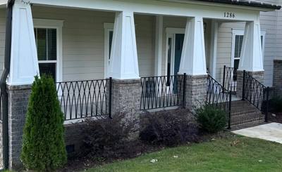 Long diamond-pattern railing across a porch with white columns