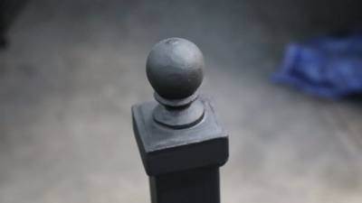 Round ball finial on a square black metal post