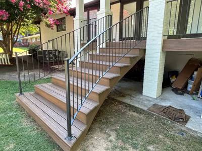 Side view of decorative black railings on wooden porch steps