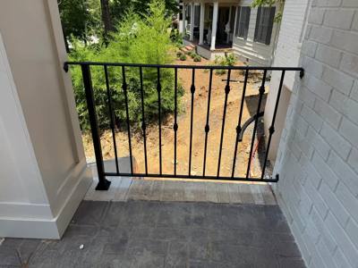 Straight black picket railing across a narrow porch opening