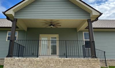 Straight black railings across a gabled covered porch