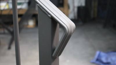 Unfinished handrail with a smooth rounded return end