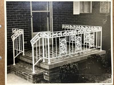 White ornamental porch railings with decorative panels and stair rails
