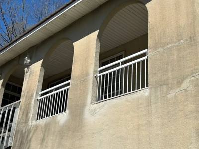 White railing across an upper balcony with tall arched openings