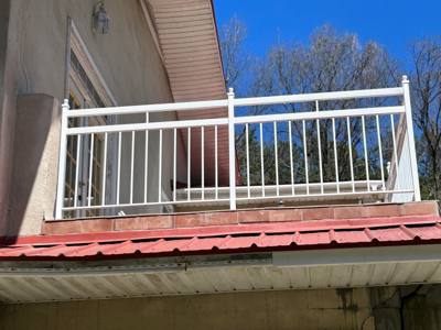White vertical-bar railing around an elevated balcony